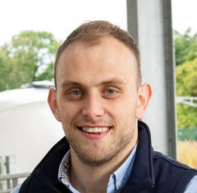 A person smiling for the camera Description automatically generated