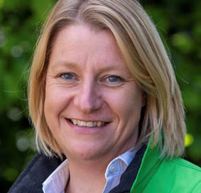 A person smiling for the camera Description automatically generated