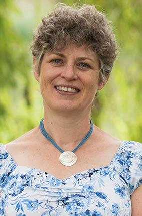 A person smiling for the camera Description automatically generated