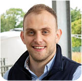 A person smiling for the camera Description automatically generated