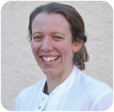 A person smiling for the camera Description automatically generated