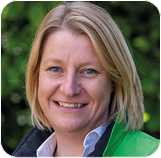 A person smiling for the camera Description automatically generated