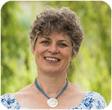 A person smiling for the camera Description automatically generated