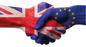 UK and European Union bilateral political relations and cooperation concept with Union Jack flag and EU flag painted on handshake.