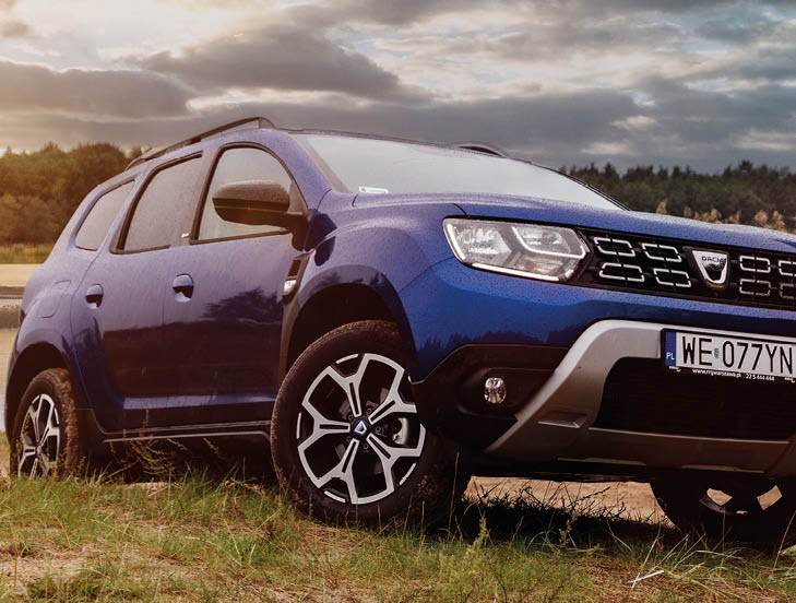 Riga, Latvia 2 October 2020 Dacia Duster (also the Renault Duster)  subcompact crossover SUV, off-road vehicle  Stands on hill of road panoramic with lake and sunset at background  