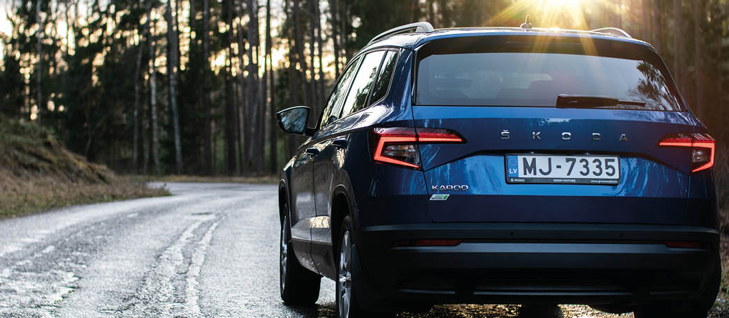 Riga, Latvia 19 February 2020 The Škoda Karoq is a subcompact crossover manufactured by the Czech automaker Škoda Auto  Driving in forest road in motion blur  Blue Škoda on Green forest background 