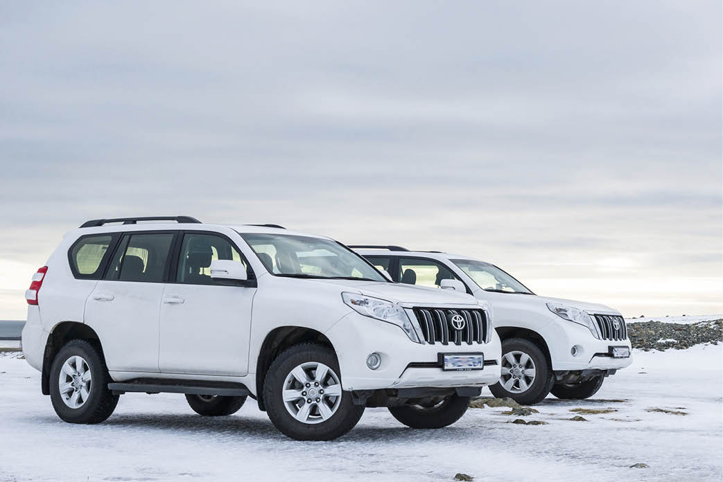 Stokksnes, Hofn,  Iceland - February 23, 2016: Two jeeps Toyota Land Cruise Prado at sunset near the Vestrahorn mountain  Winter off road driving 