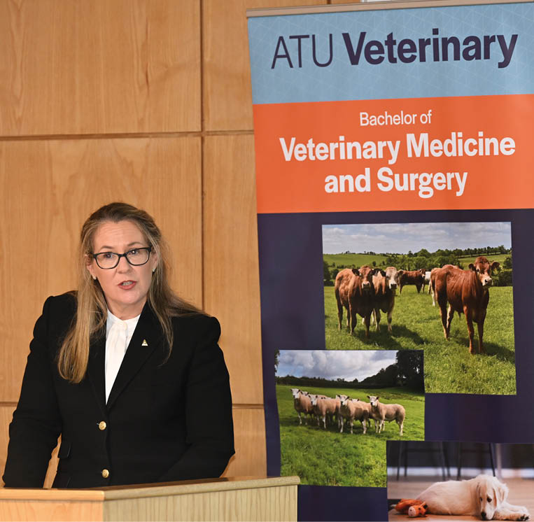 A woman is standing in front of a sign that says “ATU Veterinary". AI generated content