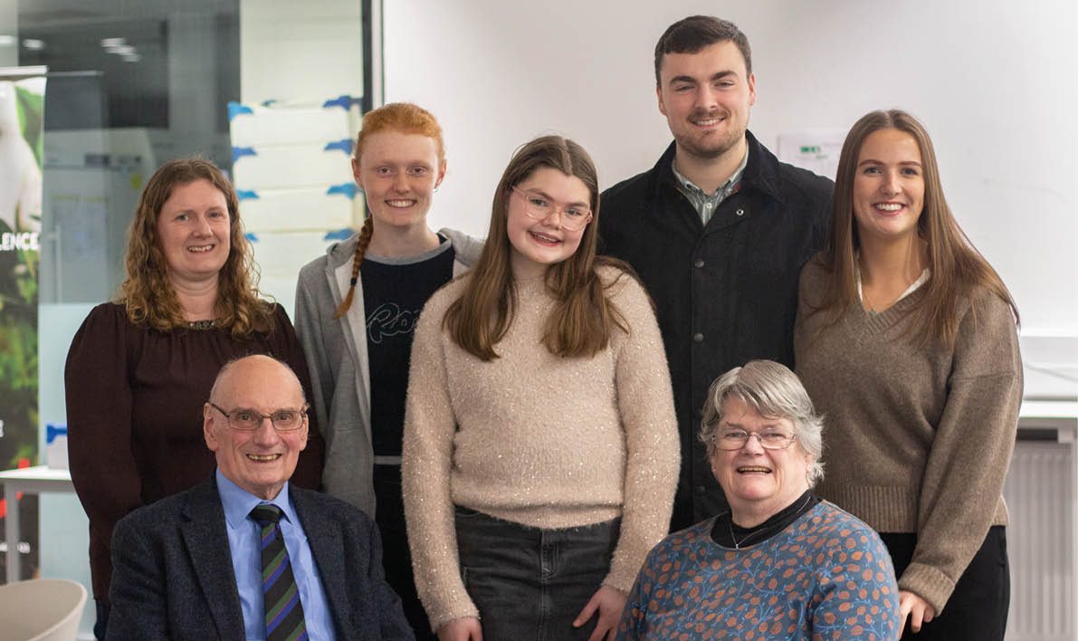 A group of people, including a man and a woman, pose for a picture. AI generated content