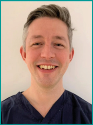 A group of people are shown in a photo, including a man with a beard and a woman with glasses. They are all smiling for the camera. AI generated content