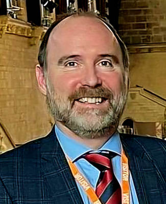 A man wearing a suit and tie is smiling for the camera. AI generated content