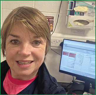 A woman is smiling in front of a computer monitor. AI generated content