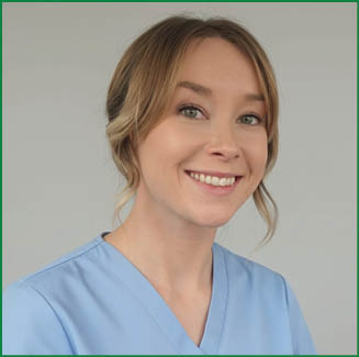 A woman wearing a blue shirt and a scrubs outfit is smiling for the camera. AI generated content