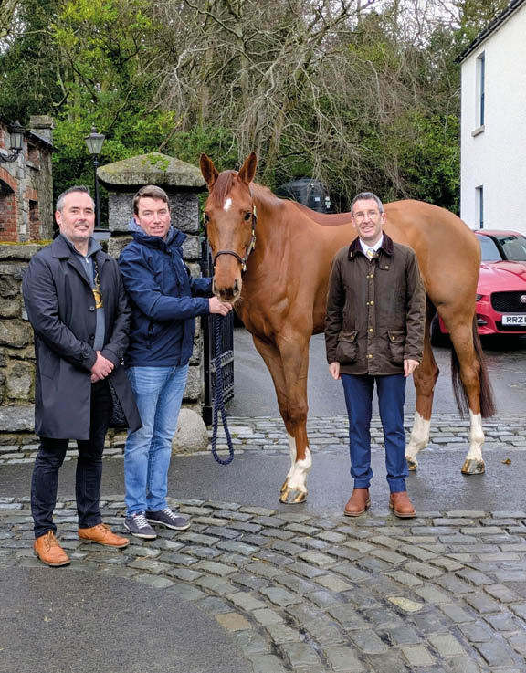 Three men are standing next to a brown horse. AI generated content