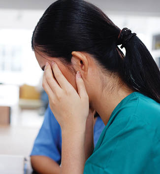 Professional Asian surgeon doctor women wears blue and green uniform is having a headache and stress together after meeting with teamwork for in the treatment of patients suffering from COVID-19 