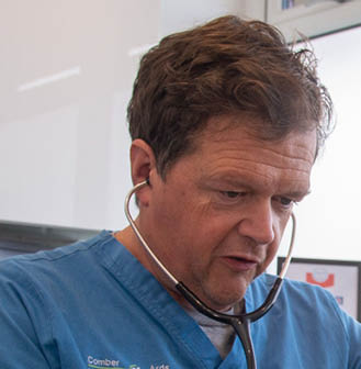 John Buick in the consulting room with patient Beans 