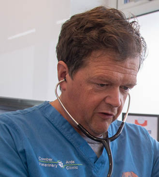 John Buick in the consulting room with patient Beans 