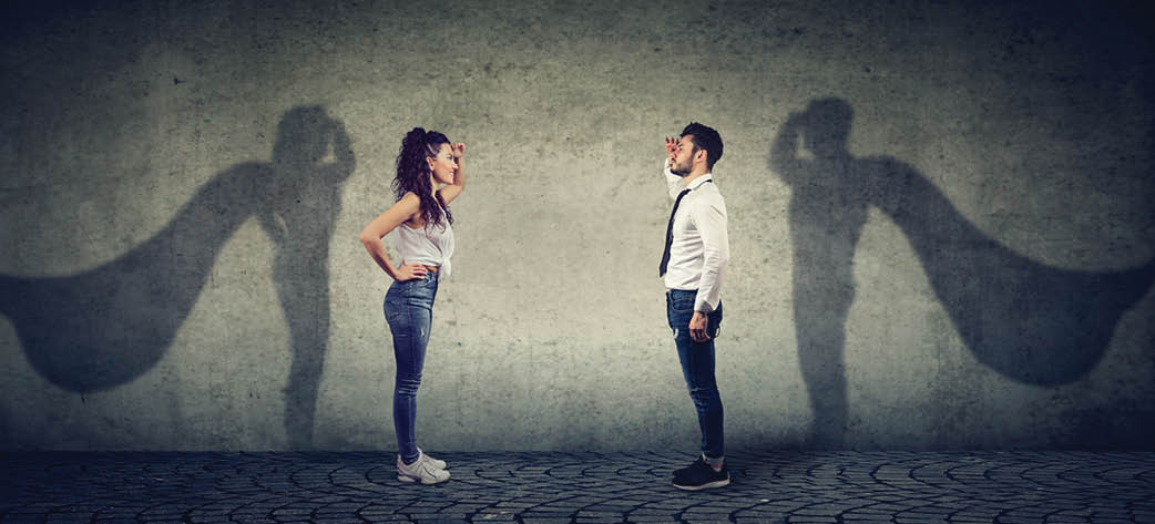 Side view of a man and woman imagining to be a super hero looking aspired. 